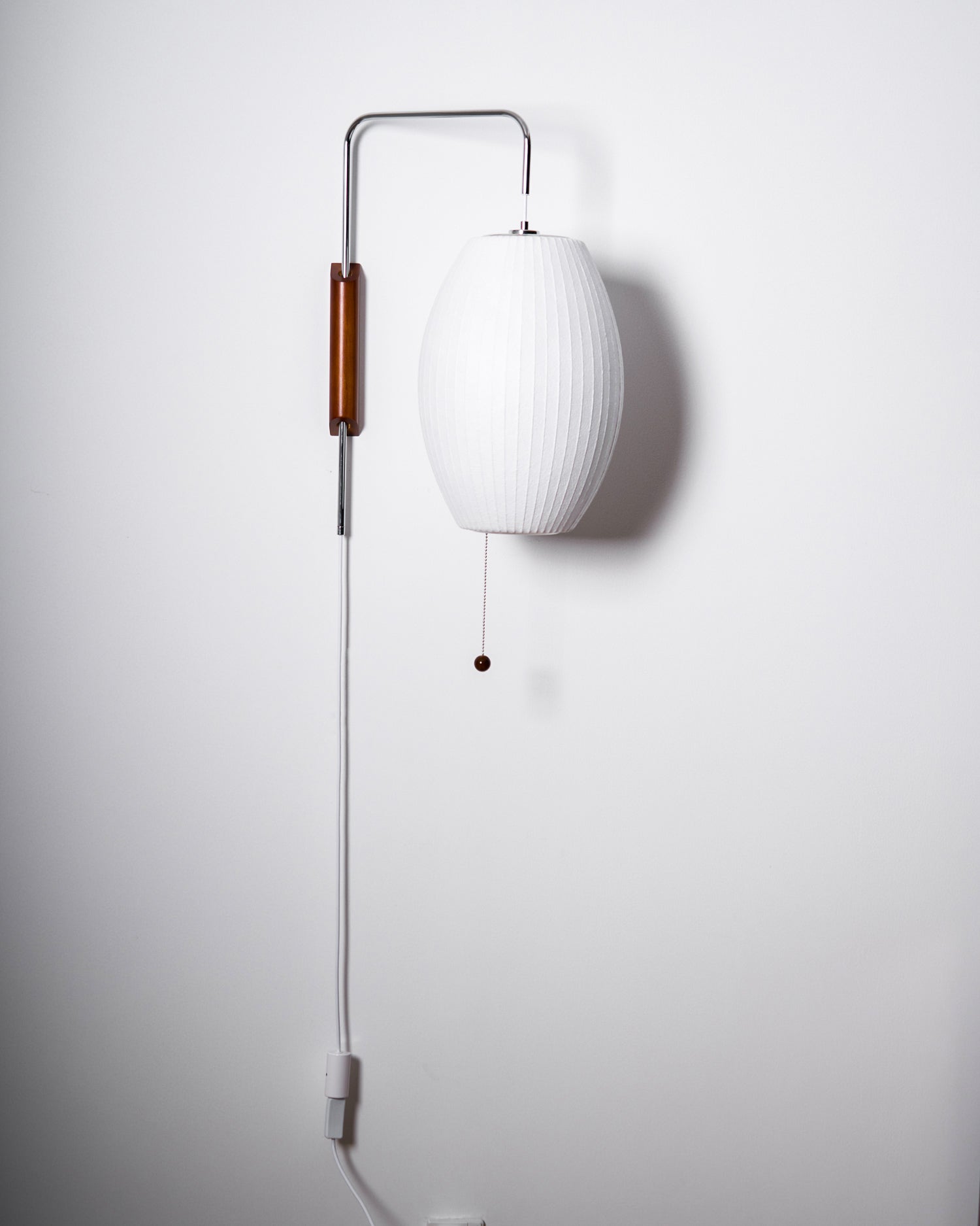 Ribbed Oval Wall Sconce With Pull Chain And Curved Arm